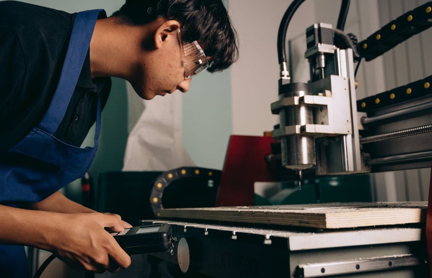 Machinist setting up a workholding fixture at a CNC machine